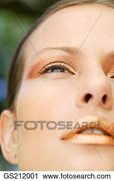 Stock Photography - lady wearing golden 
make up looking 
upwards. fotosearch 
- search stock 
photos, pictures, 
images, and photo 
clipart