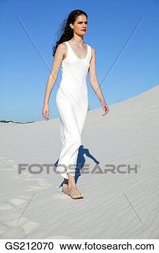 Stock Photography - lady wearing a 
long white dress, 
walking in the 
sand dunes. fotosearch 
- search stock 
photos, pictures, 
images, and photo 
clipart