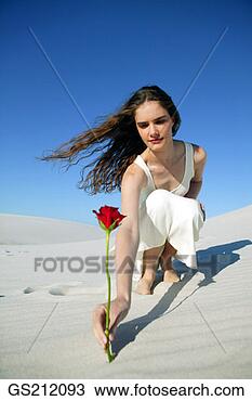 Stock Photo - lady with windswept 
hair,  crouching 
in the sand dunes, 
 standing a. fotosearch 
- search stock 
photos, pictures, 
images, and photo 
clipart