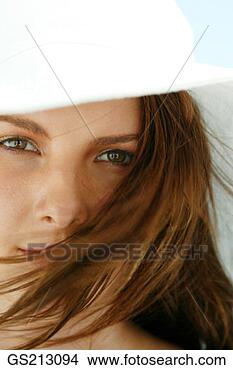 Stock Photo - close-up of a 
dark-haired woman 
wearing a sunhat. 
fotosearch - search 
stock photos, 
pictures, images, 
and photo clipart