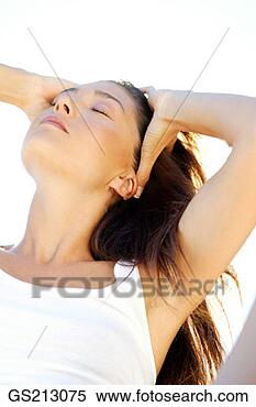 Stock Image - portrait of a 
dark-haired woman 
basking in the 
sunshine,  with 
her. fotosearch 
- search stock 
photos, pictures, 
images, and photo 
clipart