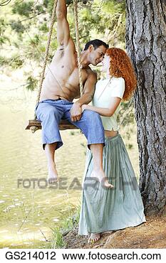 Stock Photo - man sitting on 
a swing bending 
towards his girlfriend. 
fotosearch - search 
stock photos, 
pictures, images, 
and photo clipart