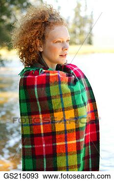 Stock Photo - red-haired woman 
wrapped up in 
a tartan rug. 
fotosearch - search 
stock photos, 
pictures, images, 
and photo clipart