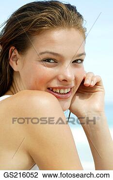 Stock Photo - portrait of a 
dark-haired woman 
looking over her 
shoulder with 
her. fotosearch 
- search stock 
photos, pictures, 
images, and photo 
clipart