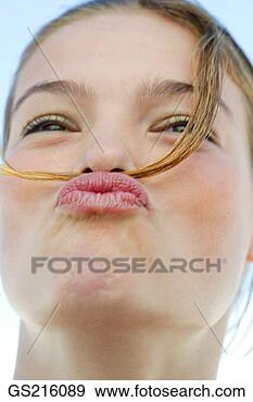 Stock Photograph - portrait of a 
dark-haired woman 
making a funny 
face. fotosearch 
- search stock 
photos, pictures, 
images, and photo 
clipart