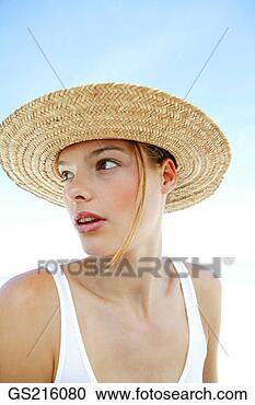 Stock Photography - portrait of a 
woman wearing 
a straw hat, looking 
behind. fotosearch 
- search stock 
photos, pictures, 
images, and photo 
clipart
