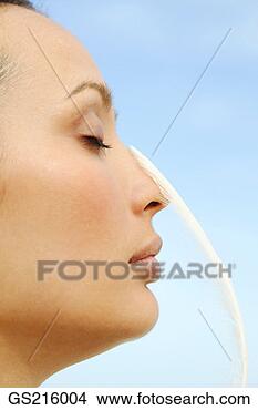 Stock Photo - side profile of 
a woman with closed 
eyes and a feather 
touching her. 
fotosearch - search 
stock photos, 
pictures, images, 
and photo clipart