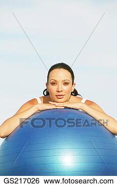 Stock Photo - woman with chin 
resting on a large 
ball. fotosearch 
- search stock 
photos, pictures, 
images, and photo 
clipart