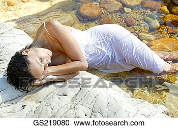 Stock Photography - clothed woman 
drying in the 
sunshine, with 
legs in the water. 
fotosearch - search 
stock photos, 
pictures, images, 
and photo clipart