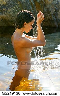 Stock Photo - side profile of 
a naked woman 
waist-deep in 
the water with 
raised. fotosearch 
- search stock 
photos, pictures, 
images, and photo 
clipart