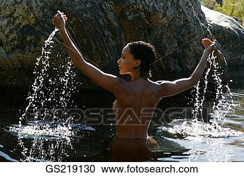 Stock Photography - topless woman 
waist-deep in 
the water with 
outstretched arms. 
fotosearch - search 
stock photos, 
pictures, images, 
and photo clipart