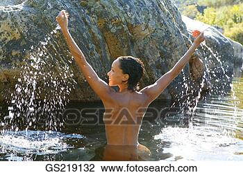 Stock Photo - topless woman 
waist-deep in 
the water with 
outstretched arms. 
fotosearch - search 
stock photos, 
pictures, images, 
and photo clipart