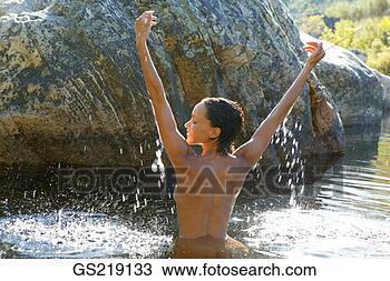 Stock Photo - topless woman 
waist-deep in 
the water with 
outstretched arms. 
fotosearch - search 
stock photos, 
pictures, images, 
and photo clipart