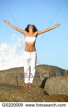 Stock Photograph - woman with outstretched 
arms and back 
to a breaking 
wave. fotosearch 
- search stock 
photos, pictures, 
images, and photo 
clipart