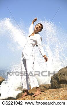 Stock Photo - laughing woman 
with outstretched 
arms getting splashed 
by a wave. fotosearch 
- search stock 
photos, pictures, 
images, and photo 
clipart