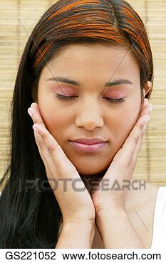 Stock Photo - portrait of a 
dark-haired woman 
with closed eyes 
and hands on cheeks. 
fotosearch - search 
stock photos, 
pictures, images, 
and photo clipart