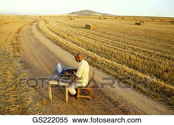 Stock Image - man sitting at 
his desk in the 
middle of nowhere. 
fotosearch - search 
stock photos, 
pictures, images, 
and photo clipart
