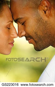 Stock Photo - side profile of 
a couple with 
closed eyes touching 
nose to nose. 
fotosearch - search 
stock photos, 
pictures, images, 
and photo clipart