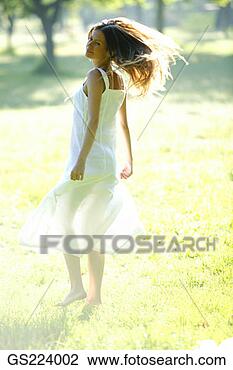 Stock Photo - dark-haired woman 
in a sundress 
turning around. 
fotosearch - search 
stock photos, 
pictures, images, 
and photo clipart