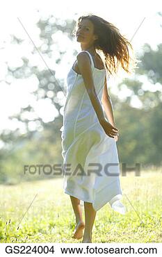 Stock Photo - dark-haired woman 
in a sundress 
turning around. 
fotosearch - search 
stock photos, 
pictures, images, 
and photo clipart