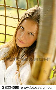 Stock Photo - portrait of a 
long-haired woman 
in a wicker chair. 
fotosearch - search 
stock photos, 
pictures, images, 
and photo clipart