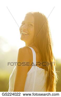 Stock Photo - smiling dark-haired 
woman looking 
over her shoulder. 
fotosearch - search 
stock photos, 
pictures, images, 
and photo clipart
