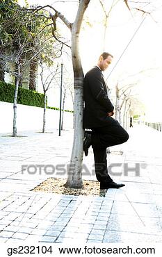 Stock Photo - businessman leaning 
against tree. 
fotosearch - search 
stock photos, 
pictures, images, 
and photo clipart