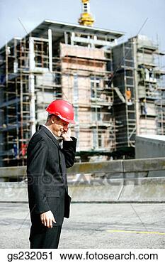 Stock Photography - businessman using 
cell phone at 
job site. fotosearch 
- search stock 
photos, pictures, 
images, and photo 
clipart