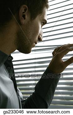 Stock Photo - man peering through 
blinds. fotosearch 
- search stock 
photos, pictures, 
images, and photo 
clipart