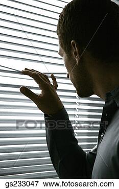 Picture - man peering through 
blinds. fotosearch 
- search stock 
photos, pictures, 
images, and photo 
clipart