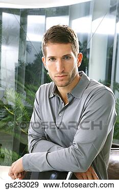 Stock Photograph - man posing indoors. 
fotosearch - search 
stock photos, 
pictures, images, 
and photo clipart