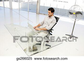 Stock Image - businessman using 
laptop in spacious 
office. fotosearch 
- search stock 
photos, pictures, 
images, and photo 
clipart