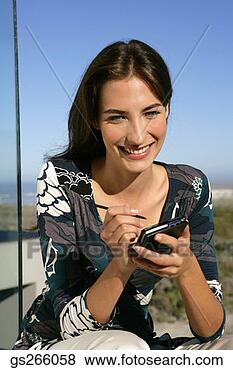 Stock Photo - woman using pda. 
fotosearch - search 
stock photos, 
pictures, images, 
and photo clipart