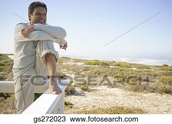 Stock Photo - man sitting on 
a railing. fotosearch 
- search stock 
photos, pictures, 
images, and photo 
clipart