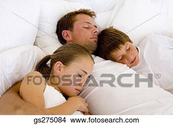 Stock Photo - daughter and son 
asleep in bed 
with father. fotosearch 
- search stock 
photos, pictures, 
images, and photo 
clipart