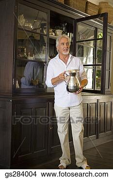 Stock Photo - middle-aged man 
holding silver 
pitcher. fotosearch 
- search stock 
photos, pictures, 
images, and photo 
clipart