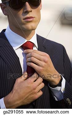 Stock Image - businessman adjusting 
necktie. fotosearch 
- search stock 
photos, pictures, 
images, and photo 
clipart