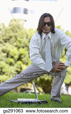 Stock Photo - businessman with 
laptop computer 
stretching outdoors. 
fotosearch - search 
stock photos, 
pictures, images, 
and photo clipart