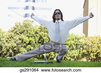 Stock Photo - businessman with 
laptop computer 
stretching outdoors. 
fotosearch - search 
stock photos, 
pictures, images, 
and photo clipart