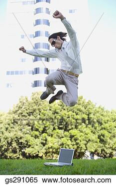 Stock Image - businessman with 
laptop computer 
jumping outdoors. 
fotosearch - search 
stock photos, 
pictures, images, 
and photo clipart