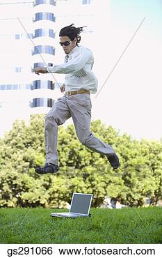 Stock Photo - businessman with 
laptop computer 
jumping outdoors. 
fotosearch - search 
stock photos, 
pictures, images, 
and photo clipart