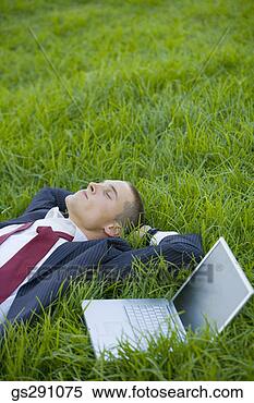 Stock Image - businessman with 
laptop computer 
lying down in 
grass. fotosearch 
- search stock 
photos, pictures, 
images, and photo 
clipart