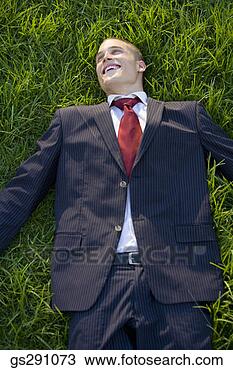 Stock Photo - businessman lying 
down in grass. 
fotosearch - search 
stock photos, 
pictures, images, 
and photo clipart