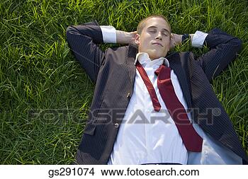 Stock Photo - businessman lying 
down in grass. 
fotosearch - search 
stock photos, 
pictures, images, 
and photo clipart