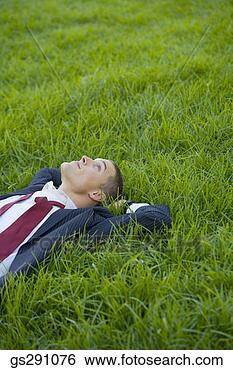 Stock Photo - businessman lying 
down in grass. 
fotosearch - search 
stock photos, 
pictures, images, 
and photo clipart