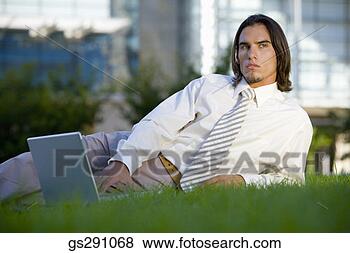 Stock Photo - businessman using 
laptop computer 
outdoors. fotosearch 
- search stock 
photos, pictures, 
images, and photo 
clipart