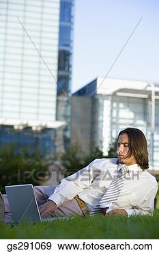 Stock Photograph - businessman using 
laptop computer 
outdoors. fotosearch 
- search stock 
photos, pictures, 
images, and photo 
clipart