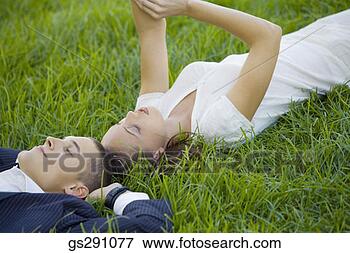 Picture - businesspeople 
lying down in 
grass. fotosearch 
- search stock 
photos, pictures, 
images, and photo 
clipart