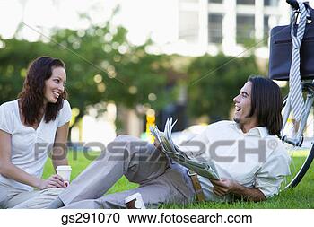 Stock Photography - businesspeople 
relaxing outdoors 
with newspaper. 
fotosearch - search 
stock photos, 
pictures, images, 
and photo clipart