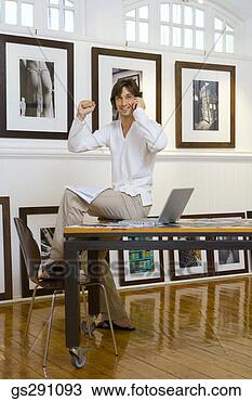 Stock Photo - happy businessman 
sitting on table. 
fotosearch - search 
stock photos, 
pictures, images, 
and photo clipart